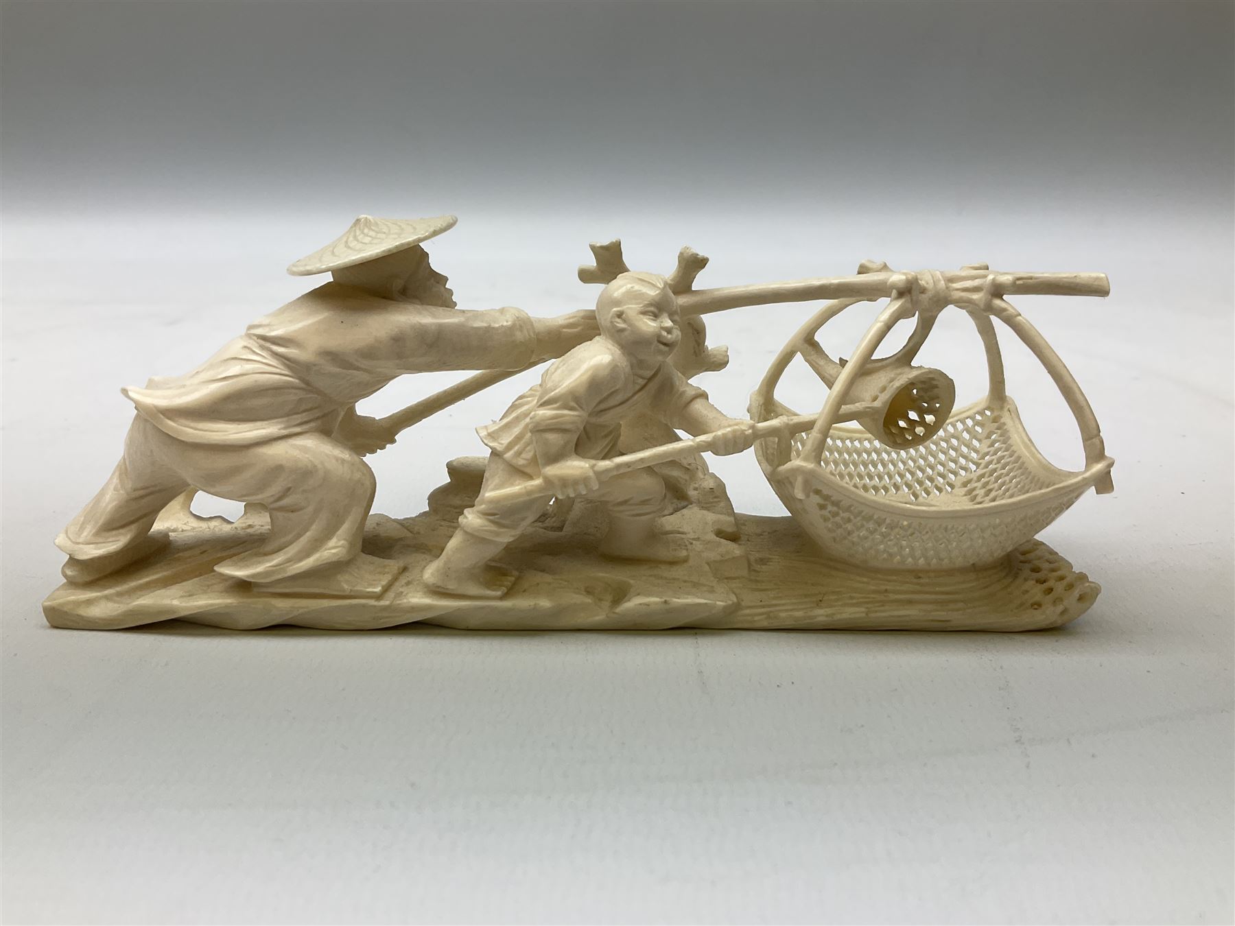 Japanese Tokyo School one piece ivory okimono, 19th century, carved as two fisherman with a net, H6cm, L15.5cm