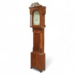 19th century-Oak and Mahogany 8-day longcase clock c 1820 (maker indistinct) with an open carved swan necked pediment and central finial, hood door flanked by turned pilasters, trunk with canted corners and a plain rectangular door, plinth with crossbanding and raised on bracket feet, painted dial with tumbling Arabic's, floral spandrels and conforming decoration to the arch, with a seconds hand, date aperture and brass stamped hands, dial pinned to a rack striking movement striking the hours on a bell. With weights & pendulum.