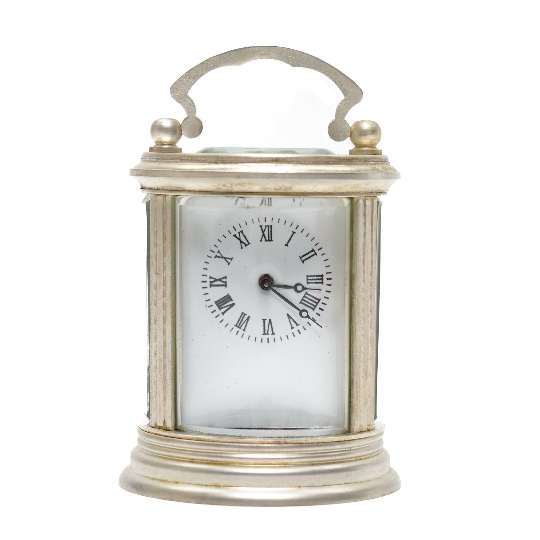 20th century-Silver plated 8-day timepiece carriage clock in an oval case, enamel dial with Roman numerals, minute track and steel moon hands, with an oval viewing class to the lever platform escapement. With key.