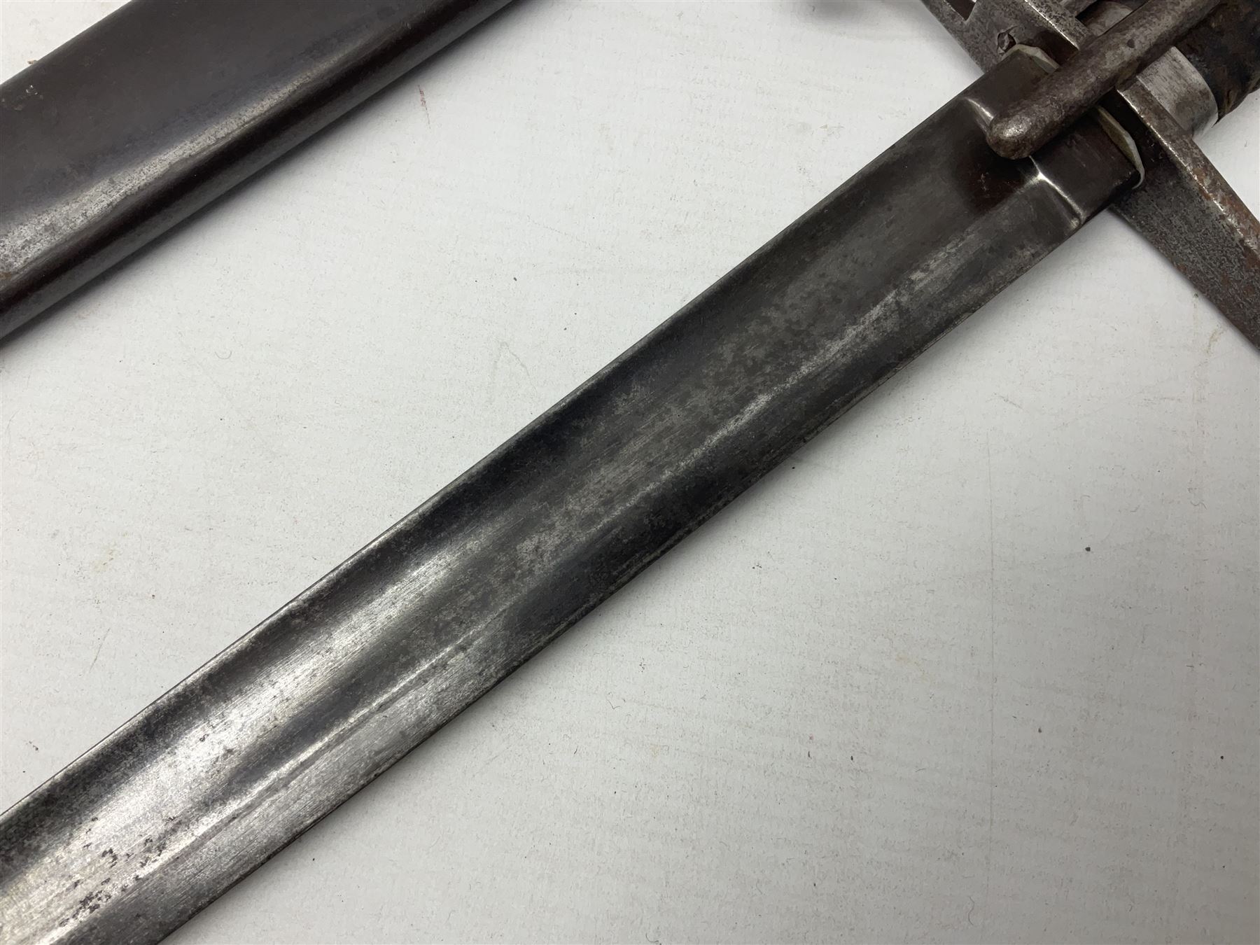 Italian M1833 Sabre with slightly curving 79cm fullered steel blade, the plain steel hilt with 'D' shaped knuckle bow, langets and wire-bound leather grip; in steel scabbard with single hanging ring L101cm overall