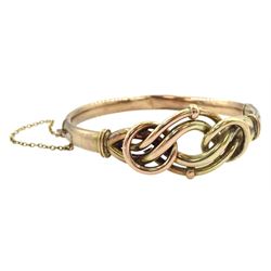 Early 20th century rose gold knot design hinged bangle, stamped 9ct
