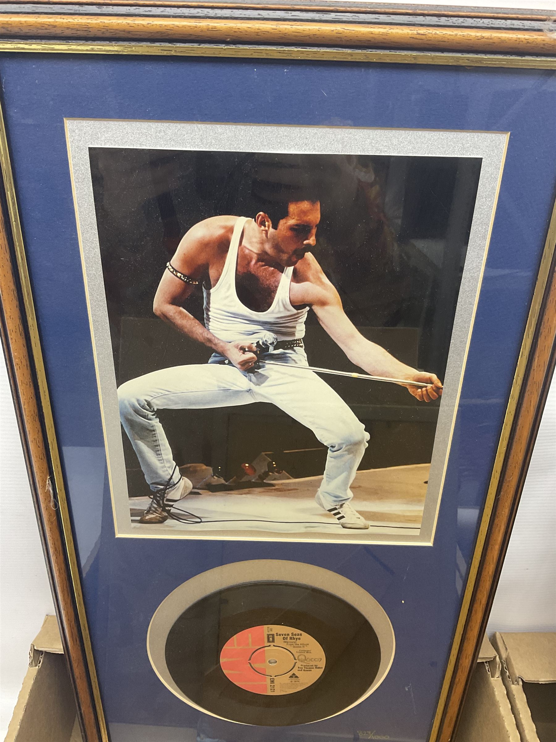 Mostly Queen and Freddie Mercury interest items, including pin badges, newspaper cuttings, diecast 'promotional' vehicles, special edition Pop Rocks figure of Freddie Mercury, VHS tapes, two charity certificates signed by Brian May and Roger Taylor, poster etc, in two boxes 