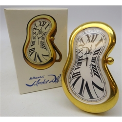  Softwatch Salvador Dali inspired strut clock, white enamel dial with Roman numerals within polished brass frame, easel back, designed by Exaequo Geneve, boxed  