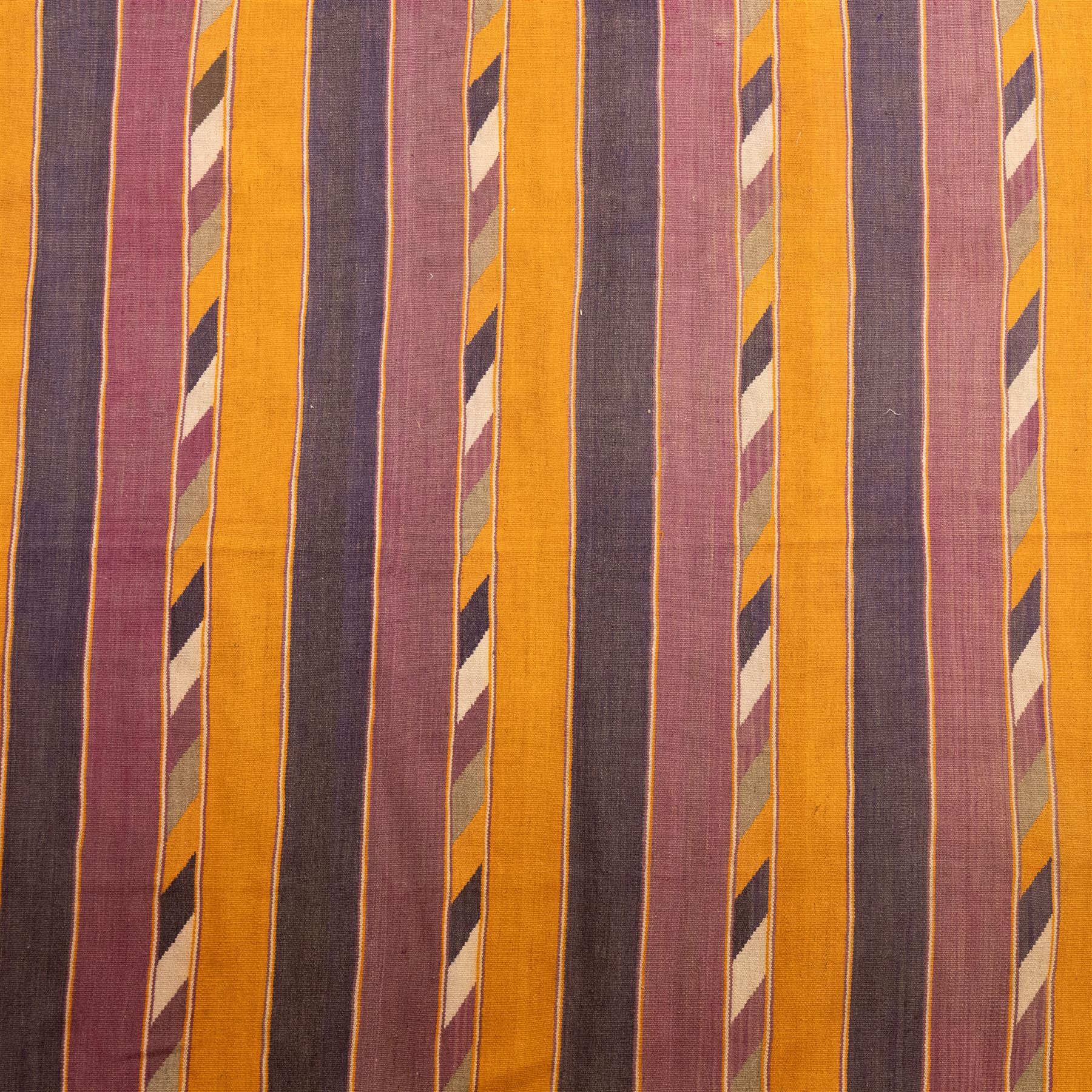 South West Persian Qashqai flatweave kilim, field decorated with bold horizontal bands in shades of aubergine, plum and orange, ochre, olive and lilac, interspersed with narrow registers of diagonal chevron motifs in cream and dark brown, framed by brown end panels, with fringe ends 