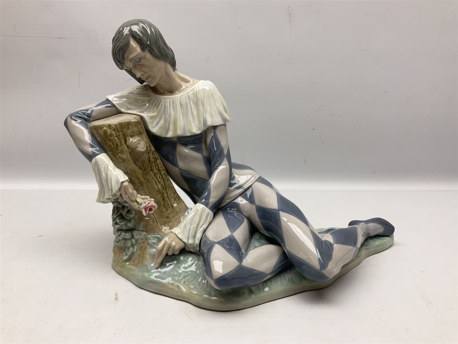 Lladro figure, Harlequin Reclining, modelled as a recumbent harlequin, no 5128, Sculpted by Salvador Furio, year issued 1982, year retired 1987, H28cm 