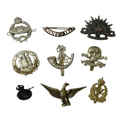 Eight metal military badges comprising Royal Tank Regiment, 17th/21st Lancers 'Death or Glory', Kings Shropshire Light Infantry, Northamptonshire and New Zealand Onward cap badges; Australian Commonwealth Military Forces Rising Sun collar badge and Australia Army Division shoulder title; and Army Catering Corps collar badge; together with brass eagle insignia (9)