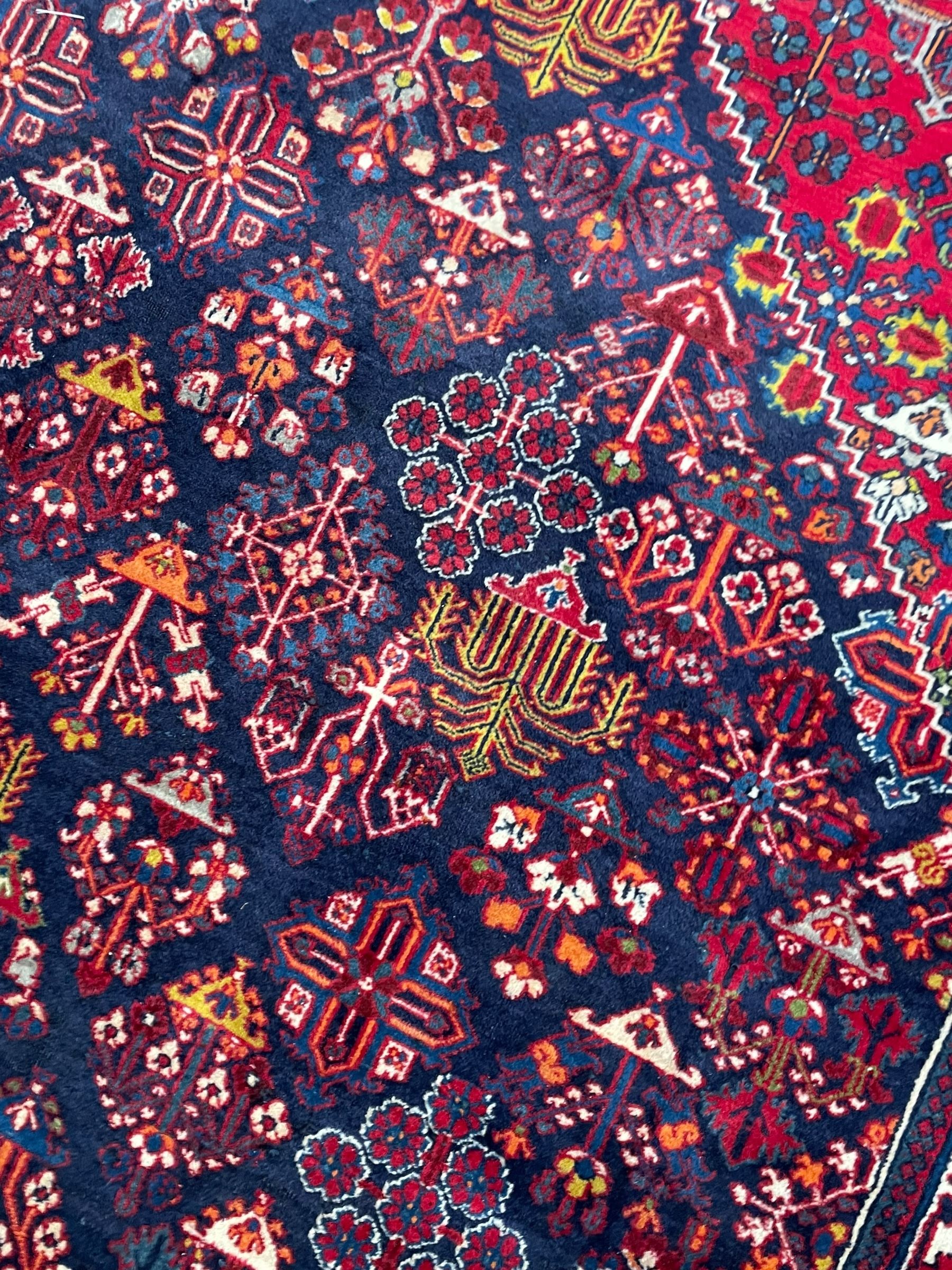 Persian Meimeh indigo ground rug, the central medallion within a field of small floral lozenge motifs, the guarded border with repeating pattern