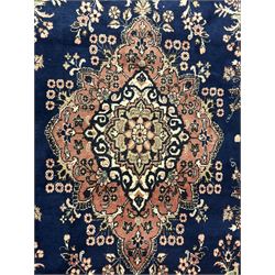 Persian Herati design indigo and red ground carpet, decorated with floral motifs, arched border