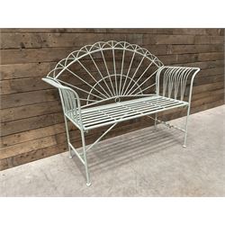 Wrought metal two seat garden bench, sunburst back, painted in pale green finish