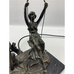 Art Nouveau style lamp in the form of a woman on a swing, with a green mottled shade, upon a marble base H52cm