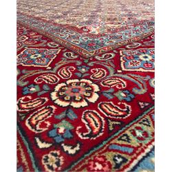 Northwestern Persian Hamadan carpet, hand-knotted, ivory field with an all-over Herati design of rosettes and serrated leaves within multiple borders, madder red with angular vine and rosette motifs, 375cm x 271cm 