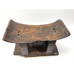 African headrest, raised on five small carved supports and a plinth base H30.5cm