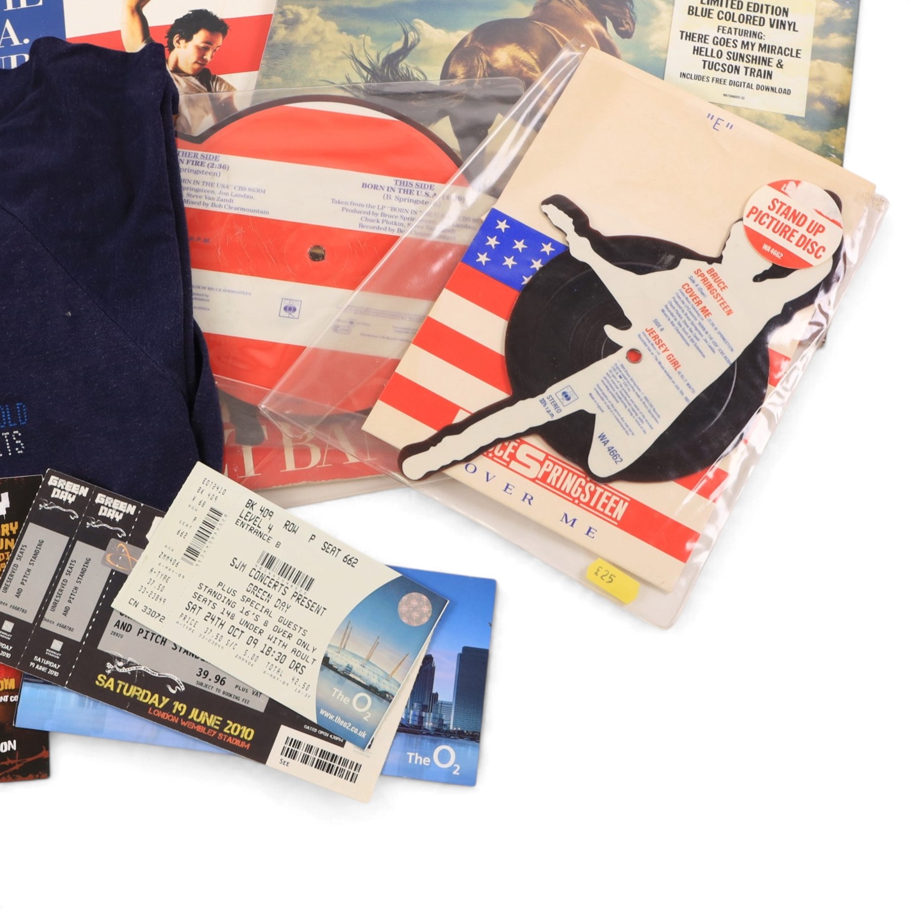 Collection of 1980s and later music tour merchandise and records, including Dire Straits Love Over Gold t-shirt, U2 Zooropa t-shirt, Bruce Springsteen Born In The USA tour programme, Bruce Springsteen Cover Me Stand Up picture disc and sleeve, Bruce Springsteen Born In The USA picture disc, Bruce Springsteen Western Stars limited edition coloured vinyl, Depeche Mode Singles Tour programme 1986-88, Journey 1986 programme and ticket stub, Journey Eclipse Collectors Edition Set and 2017 Download Festival passes
