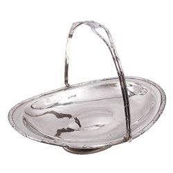 Late Edwardian silver swing handled basket, of oval form, with reed and ribbon border, upon oval foot, hallmarked James Deakin & Sons, Sheffield 1909, including handle H19.5cm