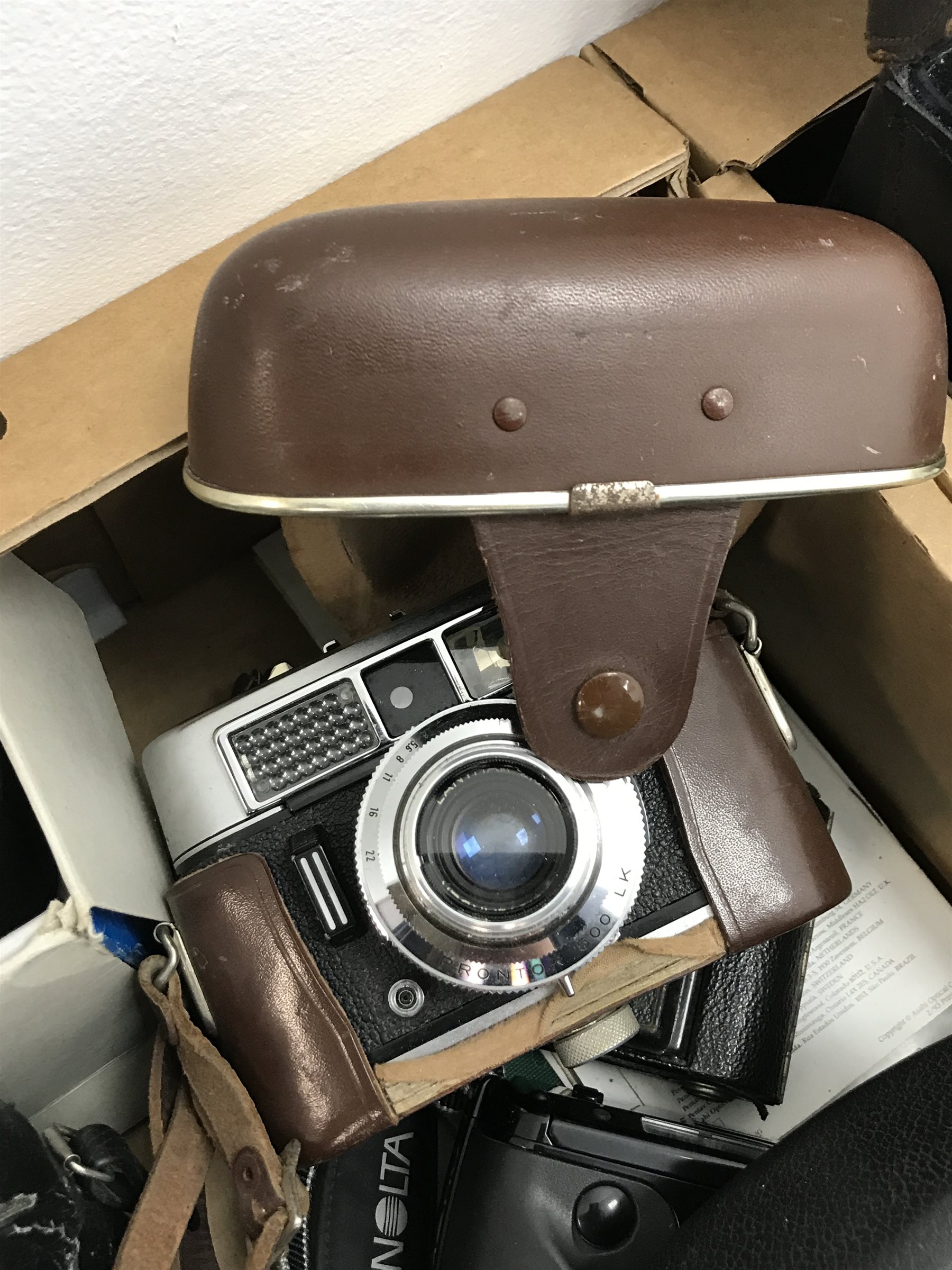 Large quantity of camera equipment in three boxes - Panasonic ZOOM C-900ZM 35mm camera, PENTAX sportmatic camera, RICOH 500 ME camera, Canon EOS 500N camera and lens boxed, Voigtlander VITO CLR camera, MAMIYA 16 camera, KODAK SIX-20 Junior, Minolta RIVA zoom 105i camera, PETRI 7 S camera, KODAK Duo 620 camera, Polaroid 600 Land Camera Spirit, auto teleplus 2x converter, Prinzflex auto 1:2.8, CANON zoom lens 80-200mm, various other cameras, lenses and cases