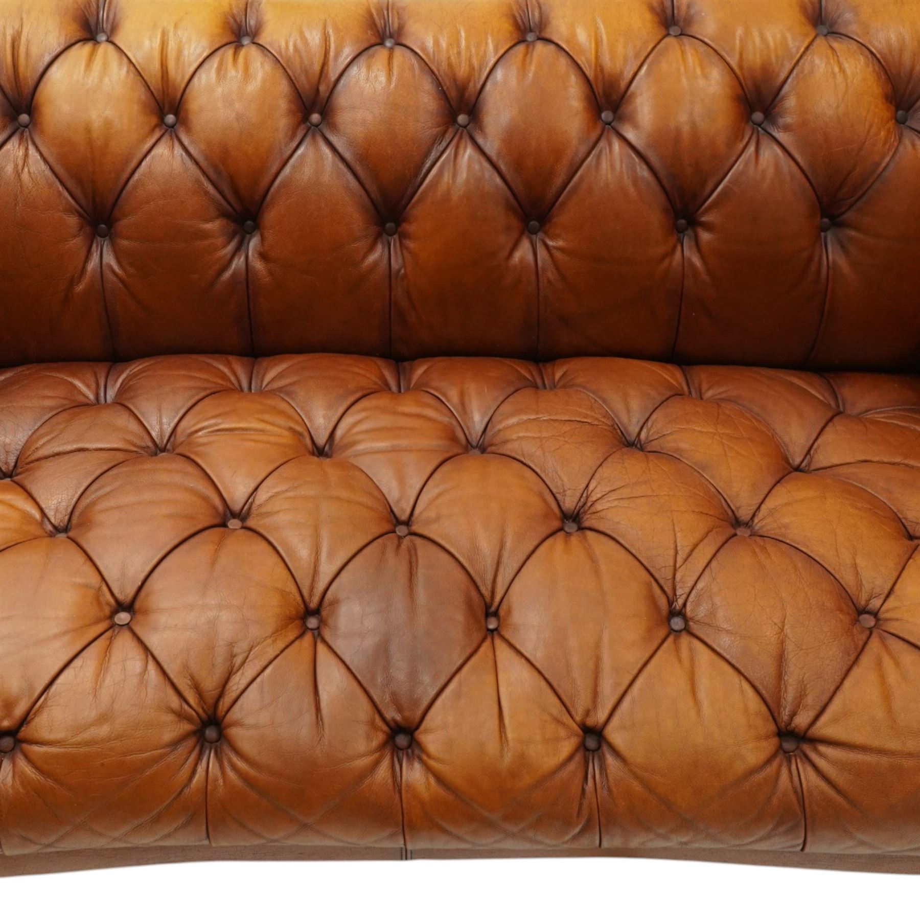 Tetrad - 'Oskar' grande three-seat sofa, Chesterfield shape with rolled arms over serpentine back and front, upholstered in fully buttoned tan leather, raised on reed-moulded feet of globular form