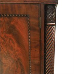  Pair of Regency mahogany bedside cabinets, rectangular top above a central cupboard door with flame mahogany veneer, flanked by spirally turned column uprights, raised on shaped supports