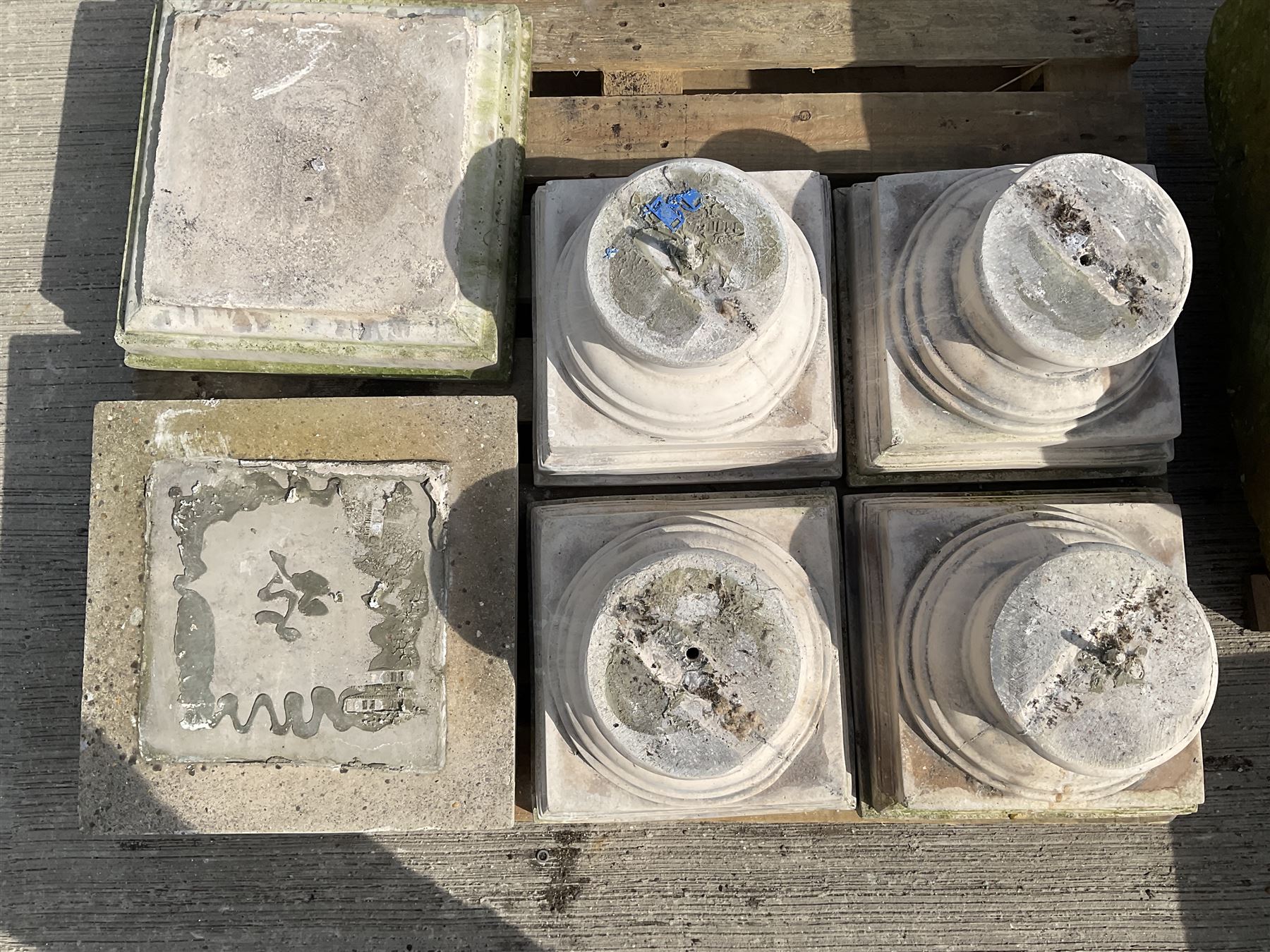 Set of four cast stone architectural columns, tapering form, on square plinth bases