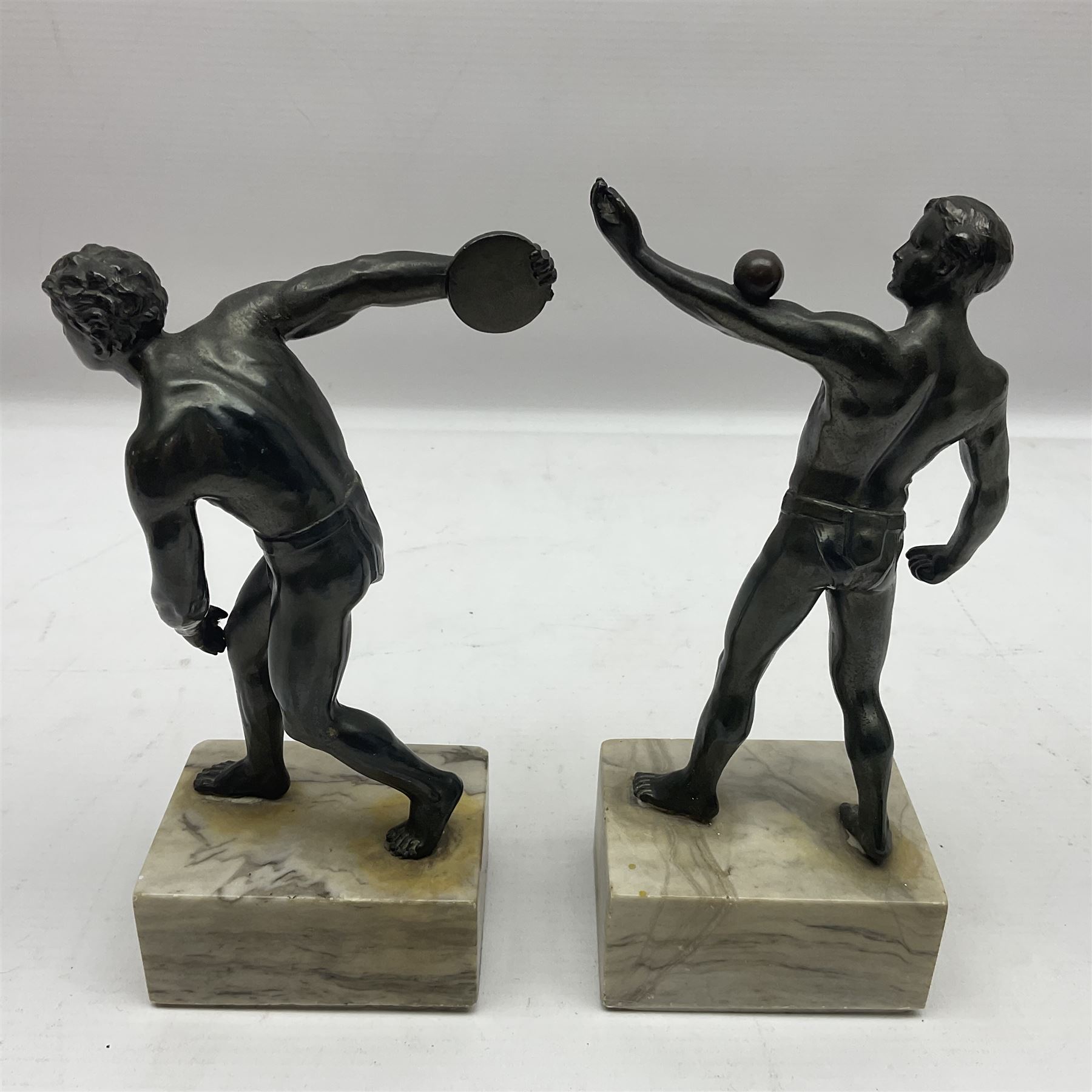 Bronzed model of the discus thrower and another of a episkyros player, both raised upon retangular plinths, H18cm