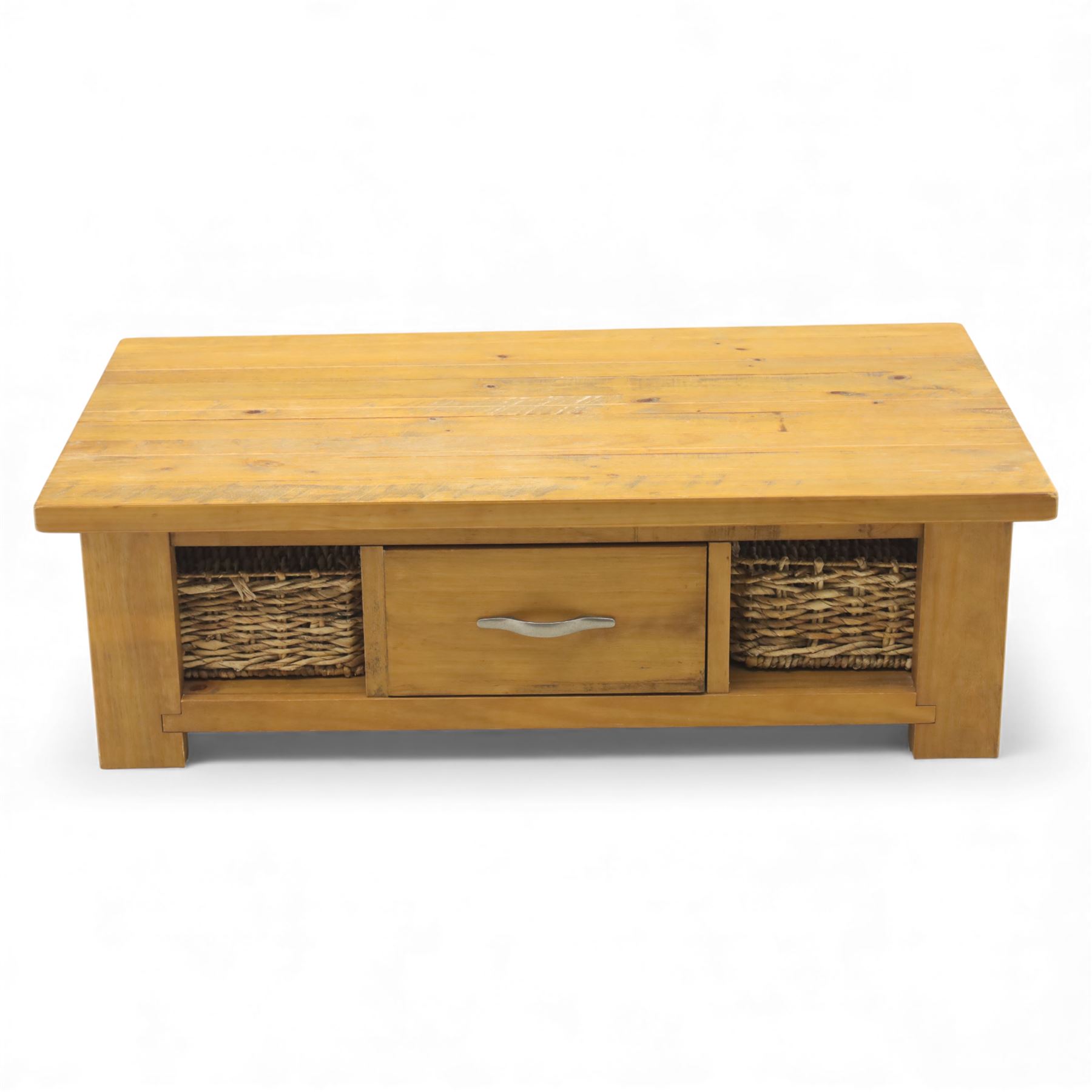 Contemporary pine coffee table, rectangular planked top with moulded edge, fitted with a central drawer to either side with brushed metal handle, flanked by two open compartments housing wicker basket drawers, plain sides, raised on square block feet