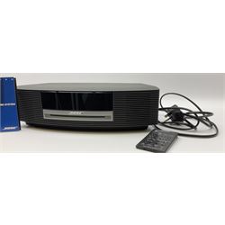 A Bose Wave music system, model AWRCC5, with remote control. 