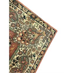 Persian design peach ground carpet, central floral medallion surrounded by scrolling foliage, decorated all over with stylised plant motifs, floral design repeating border