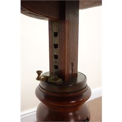 Victorian mahogany cantilever two-sided reading or bed table, shaped top with adjustable rests on turned column with locking handle, the shaped base with three bun feet, inset steel ball castors