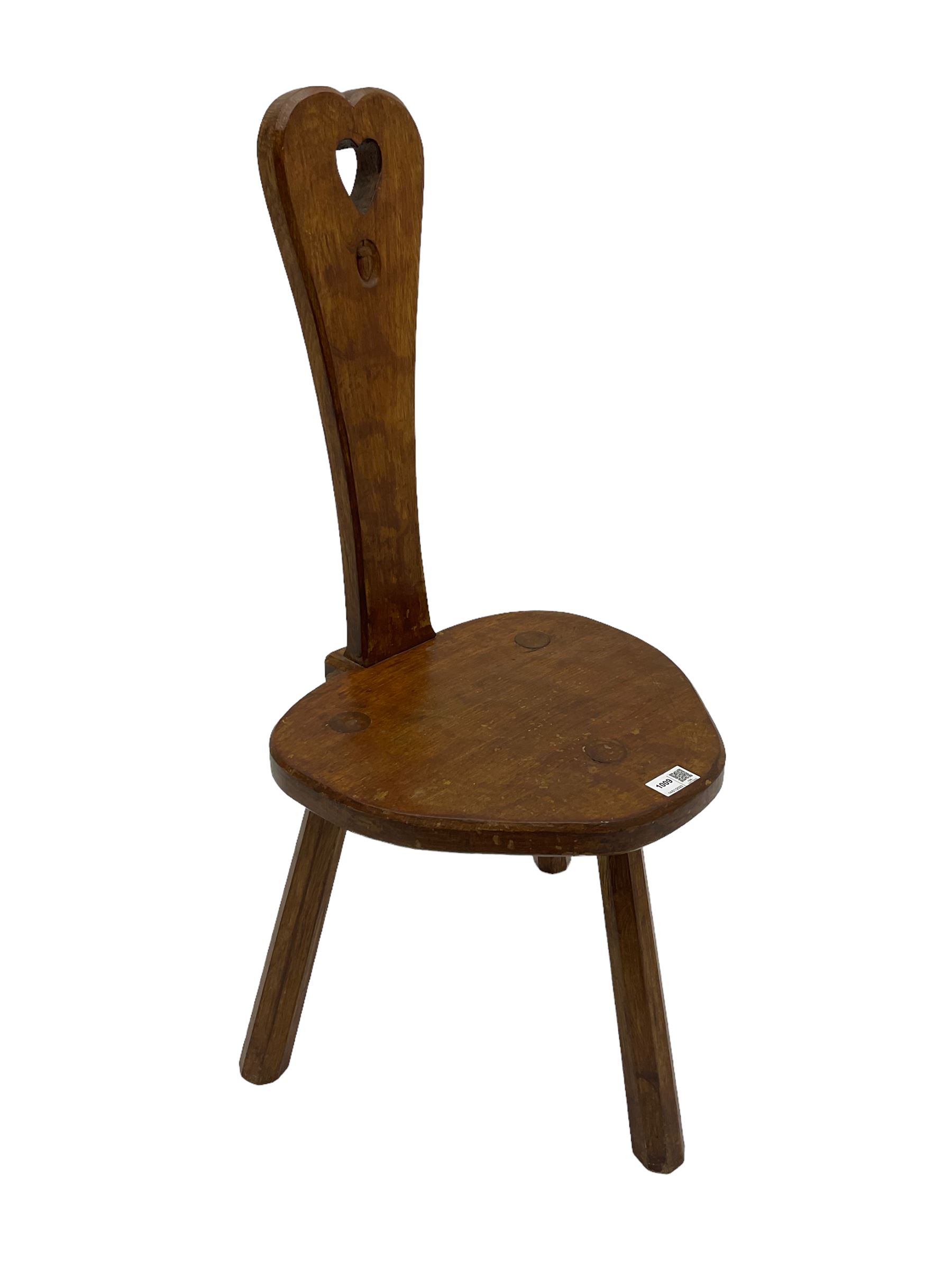 Acornman - adzed oak spinning chair, spoon shaped back with pierced heart and acorn signature, spade-shaped seat raised on octagonal tapering supports by Alan Grainger of Brandsby