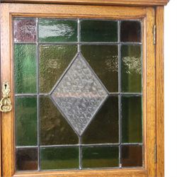 Maple & Co. - Arts & Crafts oak dresser with stained glass cupboard, raised section with pierced pediment above a mirrored back, with a stained glass fronted cupboard with fixed shelf, single long drawer, above a pair of fielded panels, with open recess above a short drawer, raised above a full length undertier with turned supports