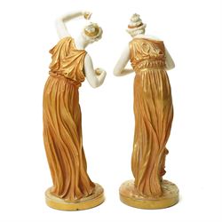 Pair of Royal Worcester figures of female musicians modelled by James Hadley, one with cymbals, decorated in gilt and on circular bases H33cm  