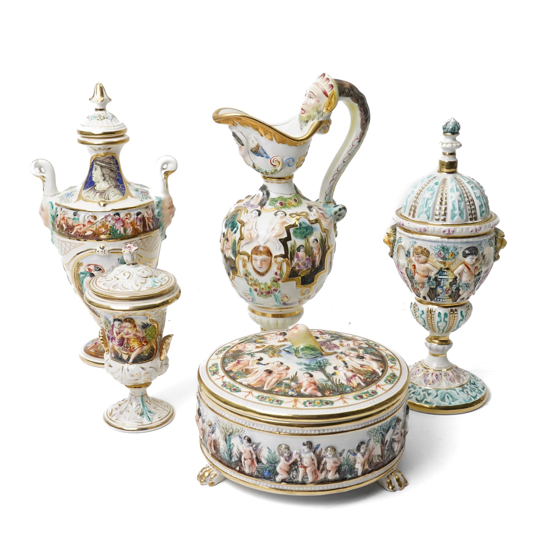Capodimonte vase and cover decorated with a raised pattern of cherubic figures H32cm, another vases and cover with panels of figures H33cm, bowl and cover with similar decoration D20cm and two other Capodimonte pieces (5)