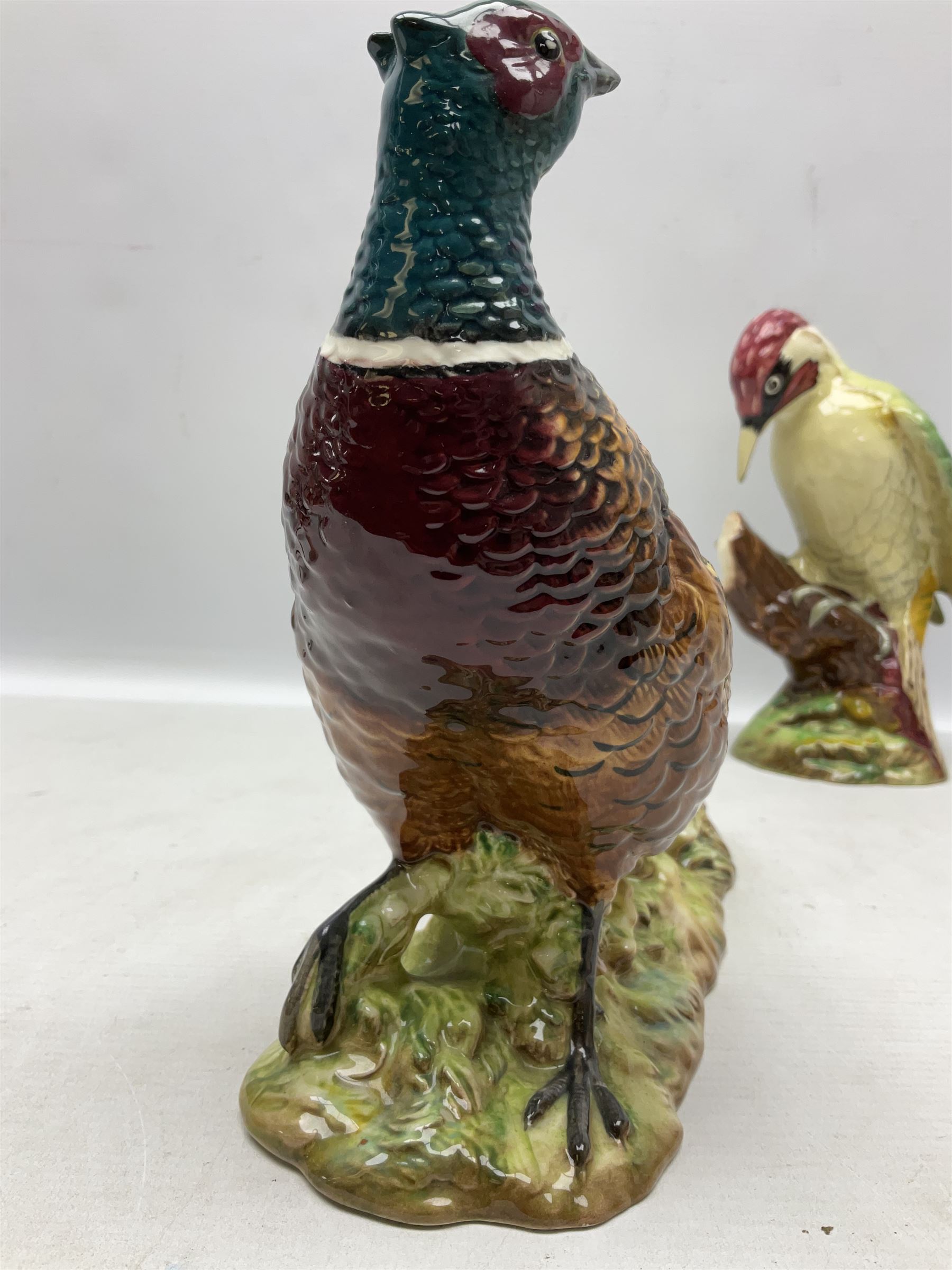 Three Beswick figures of birds, comprising pheasant no 1225, magpie no 2305 and woodpecker 1218, all with impressed marks beneath, tallest H22cm