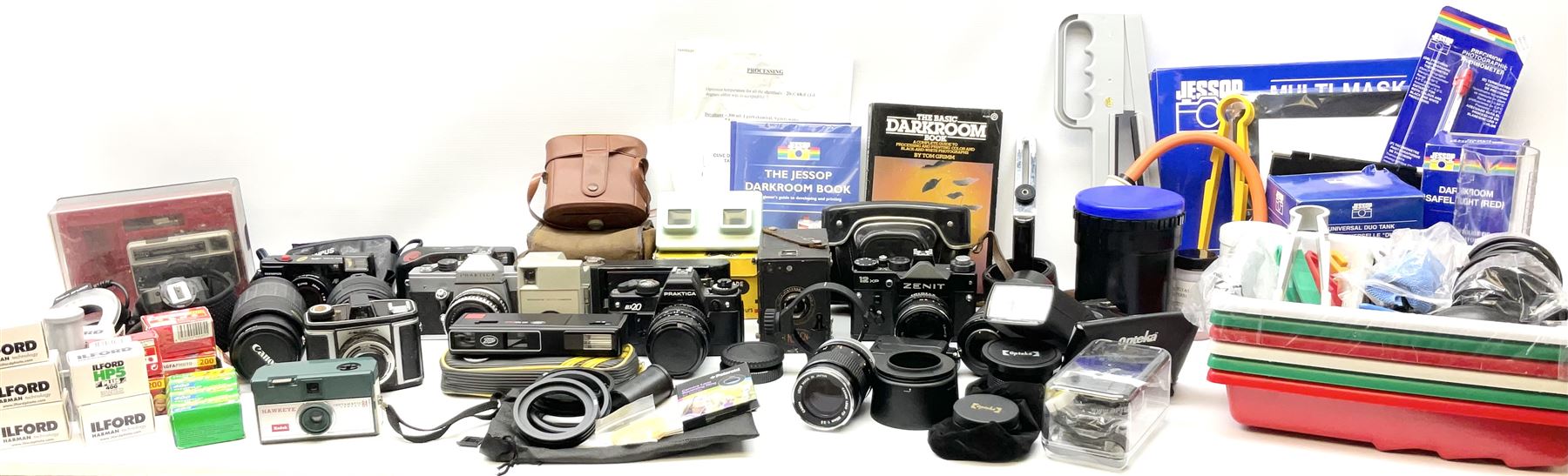 Vintage and later cameras, lenses, accessories and darkroom equipment including Zenit 12XP camera, Praktica BX20 camera fitted with 'Sigma Zoom Master 1:3.5-4.5 f=35-70mm' lens, Praktica LLC camera fitted with 'Carl Zeiss Jena Pancolar 1.8/50' lens, Canon Zoom Lens 'EF 100-300mm 1:5.6', various Jessop and other makers darkroom items including safelight (Red), universal duo tank, multi-mask enlarging easel etc, in three boxes