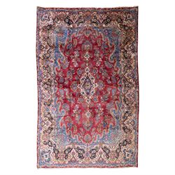 Large Central Persian Kirman hand-knotted carpet, raspberry red field, with central shaped...