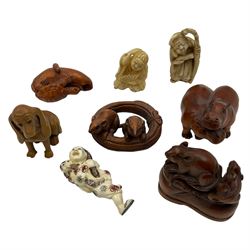 Eight wooden and composite carved netsukes, to include dog, hippos, rats etc 