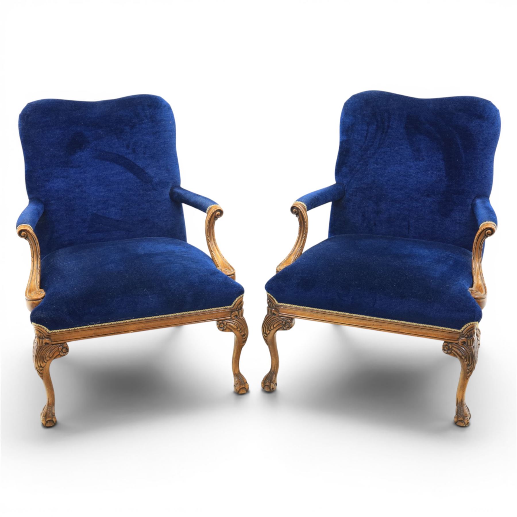Pair of George II design Gainsborough armchairs in deep blue upholstery, shaped back over scrolled and carved arms, with cabriole supports and carved shell knees terminating in claw on ball feet