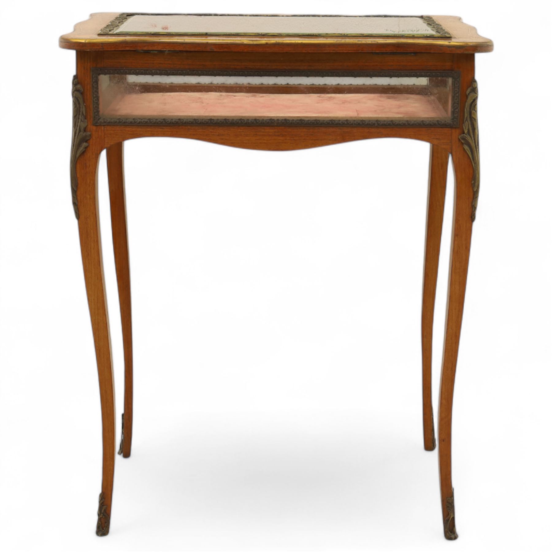 Louis XV revival style walnut bijouterie table, rectangular serpentine form, with brass edging and a hinged floral marquetry inlaid lid with bevelled glass top and sides, gilt-bronze beaded border, interior lined with rich red velvet, raised on slender cabriole legs with gilt bronze masks and sabots, circa 1900