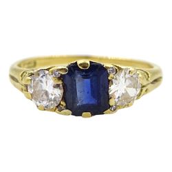 Early 20th century 18ct gold three stone emerald cut sapphire and old cut diamond ring, with four diamond accents set between, maker's mark M&W, stamped 18ct, total diamond weight approx 0.50 carat, sapphire approx 0.95 carat