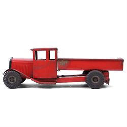 Tri-ang/Line Bros Ltd tin plate tipper truck, red body with black rubber wheels and red seat and steering wheel to interior, H49cm, L16cm