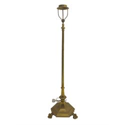 20th century brass finished floor lamp, telescopic stem on a shaped hexagonal platform base, raised on ball and claw feet (lowest height 136cm, measurement does not include shade fitting)