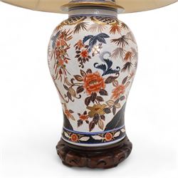 Large Chinese baluster form table lamp, modelled as a vase and cover and painted with bamboo, flowers and rockwork, on hardwood base with shade H54cm, excluding fitting