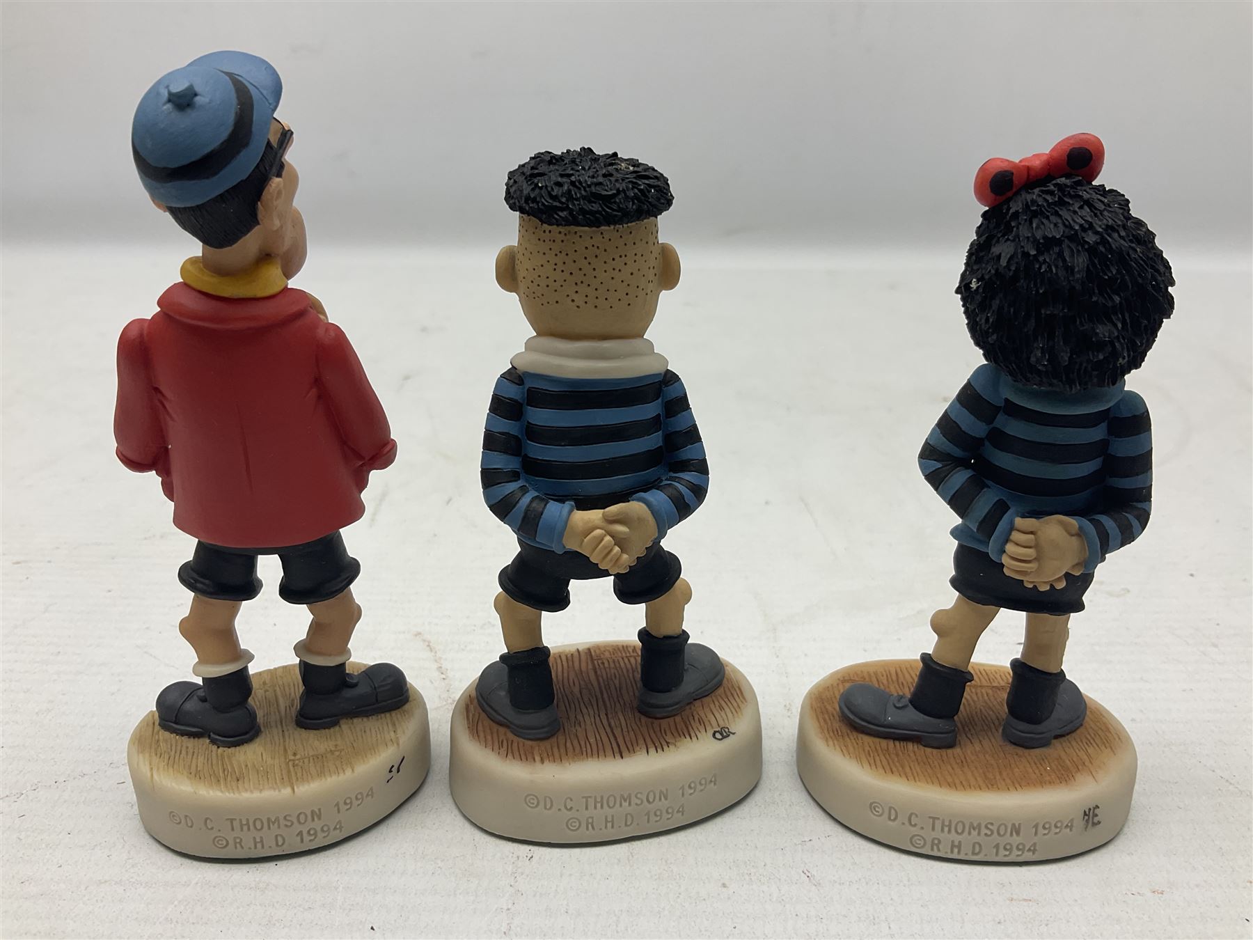 Thirteen Robert Harrop figures from the Beano Dandy collection, comprising Yo-Yo Collectors Piece 1996, Desperate Dan BD03, Cuthbert Cringeworthy BD08, Teach BD06, 'Erbert BD14, Toots BD12, Winston BD17, Fatty BD07, Dennis The Menace BD01, Dennis the Menace Fishing BD806, Sydney BD13, Wilfrid BD15 and Plug BD11