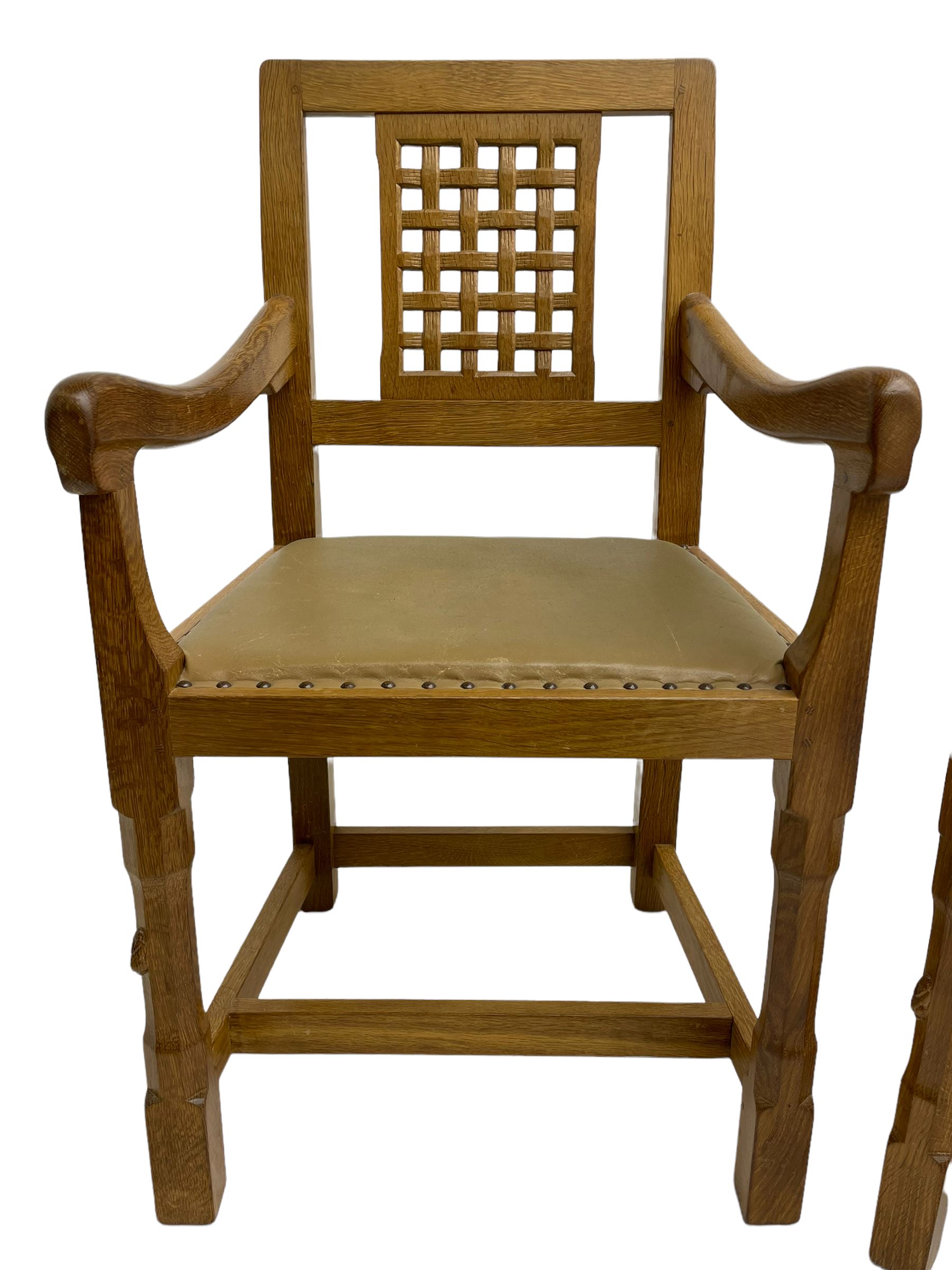 'Rabbitman' set of eight oak dining chairs, pierced lattice backs, upholstered seats with studwork band, octagonal front supports joined by stretchers, carved with rabbit signature, two carvers and six side chairs, by Peter Heap of Wetwang
