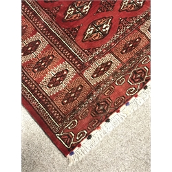 Turkman Tekke Bokhara red ground rug, the field and border decorated with guls, 177cm x 213cm