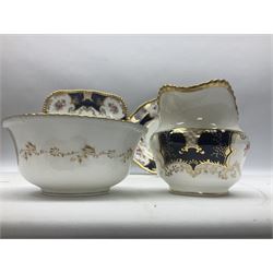 Coalport cobalt blue batwing pattern tea wares, decorated with finely enamelled floral sprays within gilt reserves, comprising teacup trio, coffee can and saucer and other cup and saucer, twin handled cake plate, milk jug and open sucrier, and circular plate retailed by T. Goode & Co London, pattern no Y2665,  all with green Coalport AD 1750 marks beneath, largest W26cm (11)