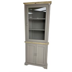 Contemporary teal and oak finish corner cabinet, single glazed door enclosing two shelves, over two panelled cupboard doors
