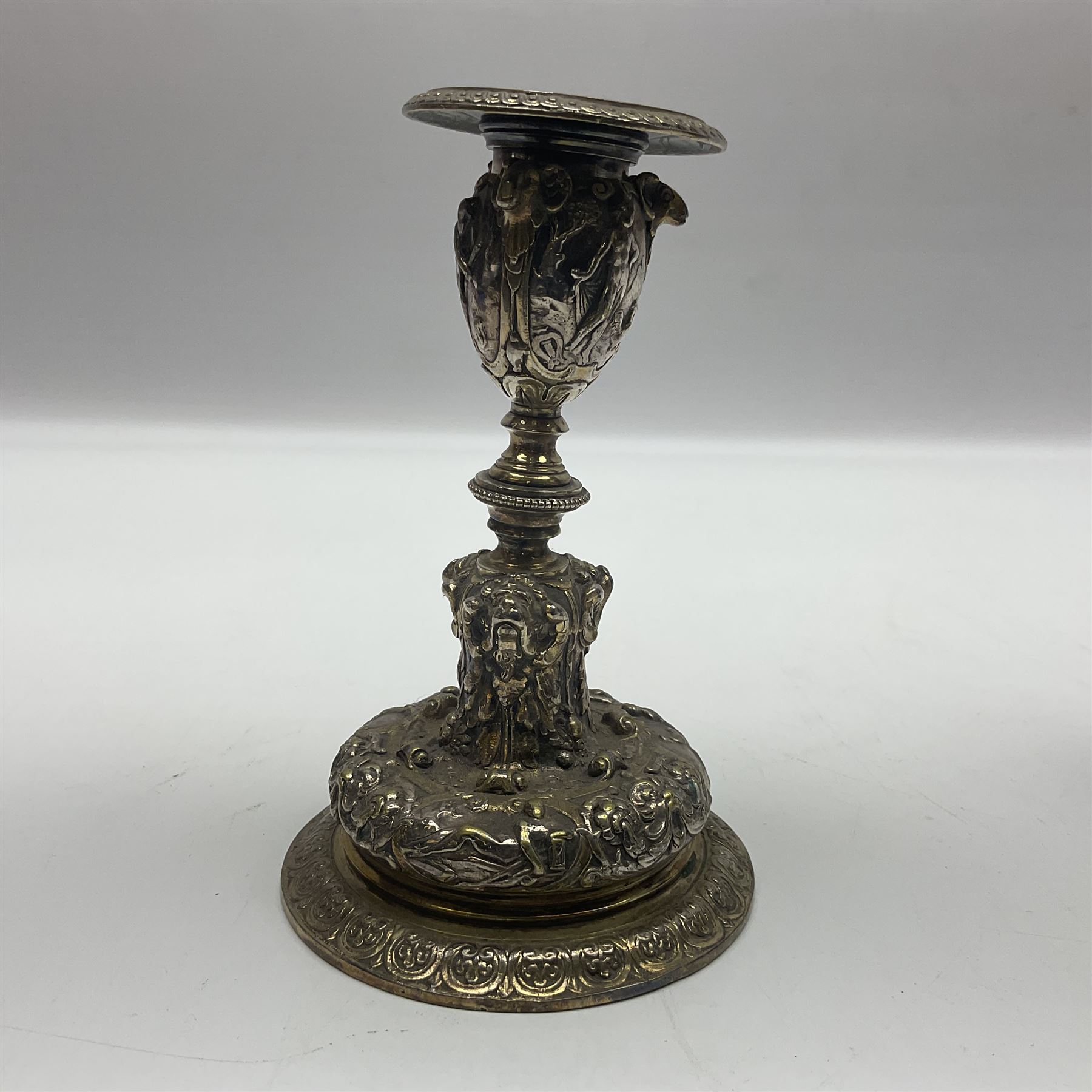Pair of Victorian Elkington Mason & Co silver plated candlesticks, decorated in relief with ram masks and figures, H14cm