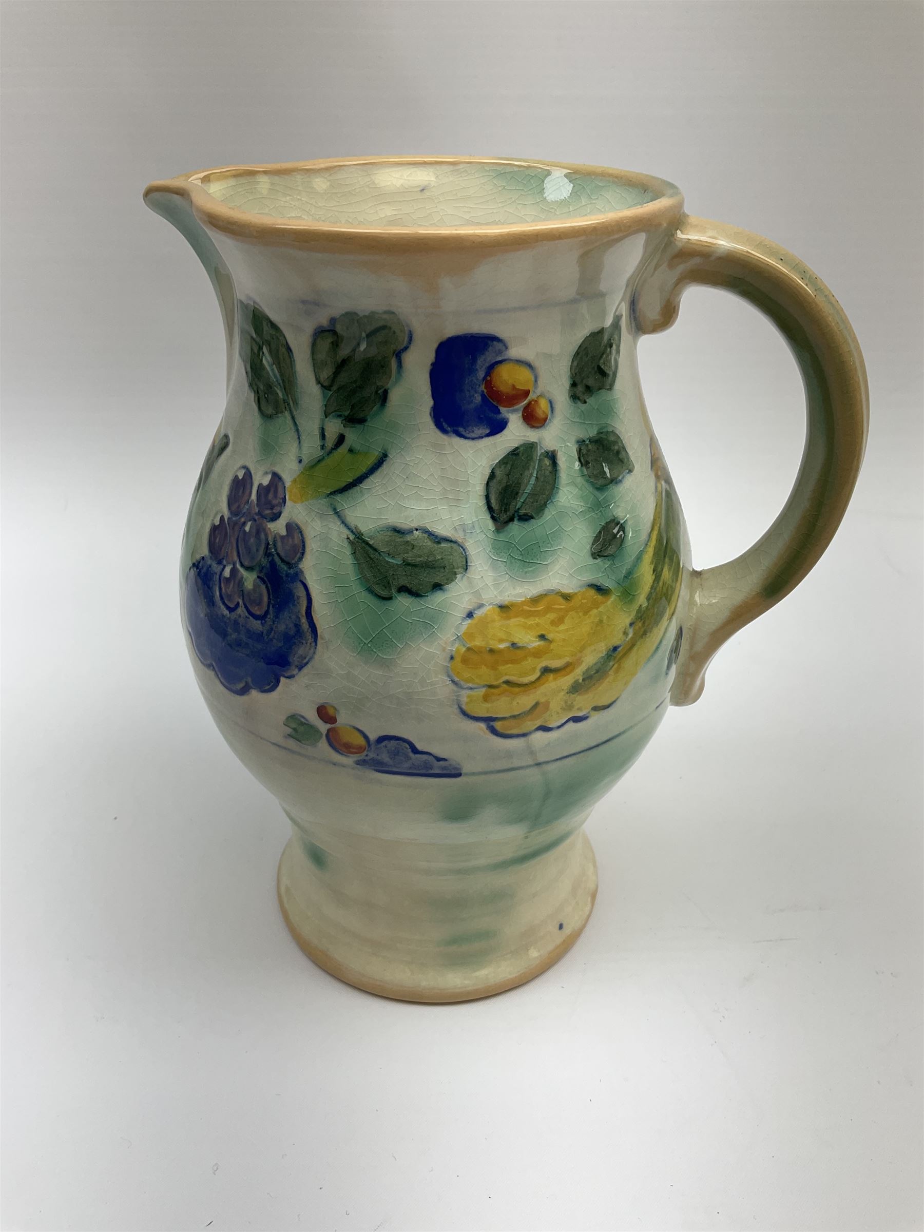 Early 20th century Royal Doulton Brangwyn Ware jug and set of six beakers, designed by Frank Brangwyn RA, all decorated in the Harvest pattern with stylised leaves and fruit on mottled peach and green ground, all with printed marks beneath, date code for 1920s, largest H18cm