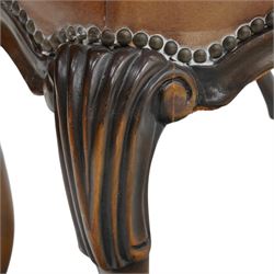 Pair of quality Queen Anne design mahogany framed wingback armchairs with matching footstools, the high sprung winged backs over rolled arms with studwork, raised on elegant reeded scroll carved cabriole supports, upholstered in deep chocolate brown leather (W82cm D75cm H112cm), the footstools with ovoid padded seat over studwork and moulded lower rail and cabriole supports (W65cm D42cm H48cm)