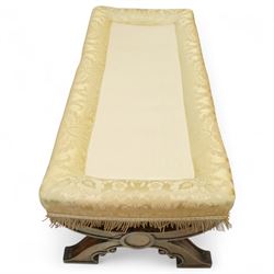 Late Victorian Gothic revival walnut long stool, rectangular padded seat upholstered in cream damask with tasselled corners and fringe border, raised on twin X-frame supports united by a turned stretcher, circa 1880